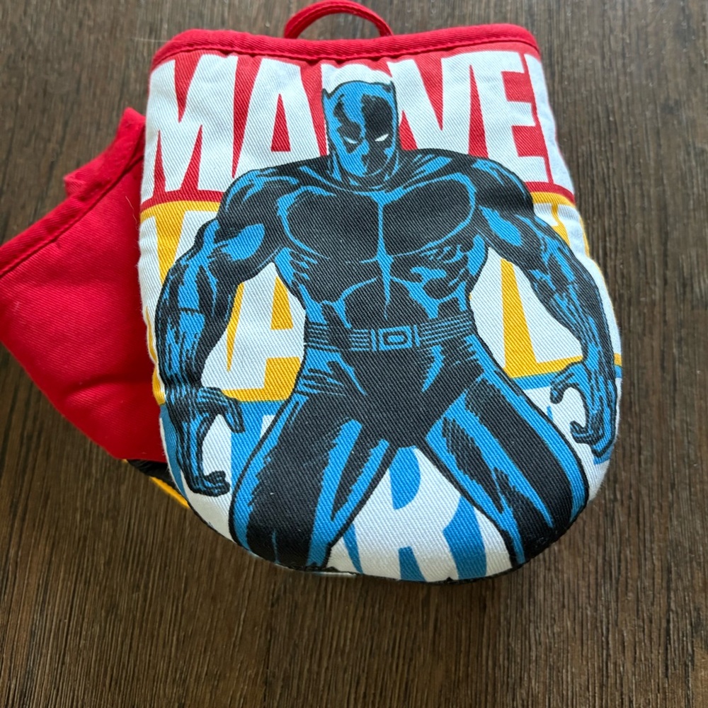 Set of brand new Marvel Black panther oven mitts.  Black heat resistant palm.